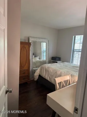 a bedroom with a bed and a mirror