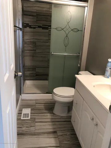a bathroom with a toilet and a shower