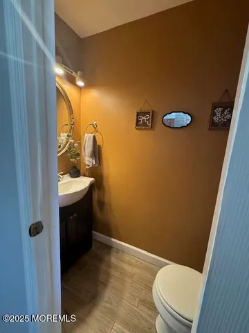 a bathroom with a sink a toilet a mirror and shower
