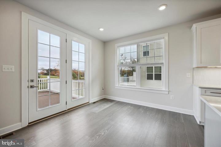 325 Piper Lane Exton, PA 19341 - Photo 11 of 24 an empty room with wooden floor and windows
