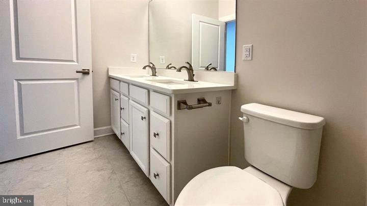 325 Piper Lane Exton, PA 19341 - Photo 19 of 24 a bathroom with a sink a toilet and mirror