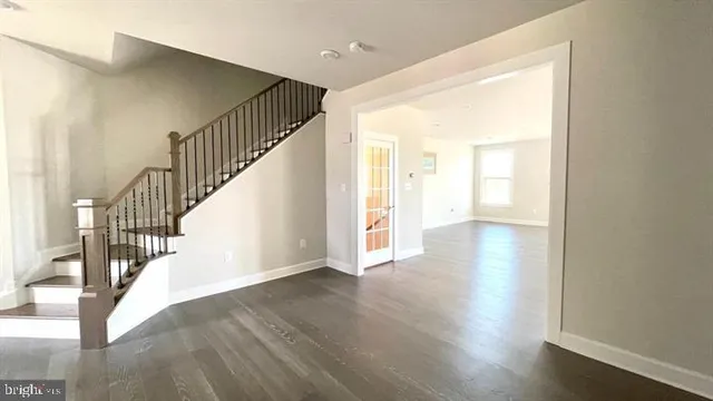 a view of an entryway with wooden floor