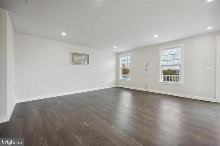 325 Piper Lane Exton, PA 19341 - Photo 7 of 24 an empty room with wooden floor and windows