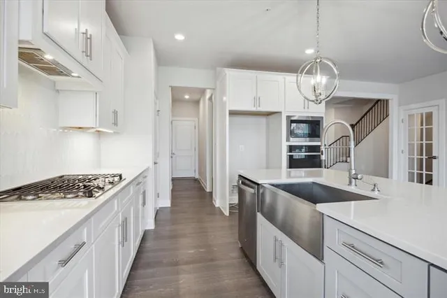 a kitchen with stainless steel appliances granite countertop a sink and stove