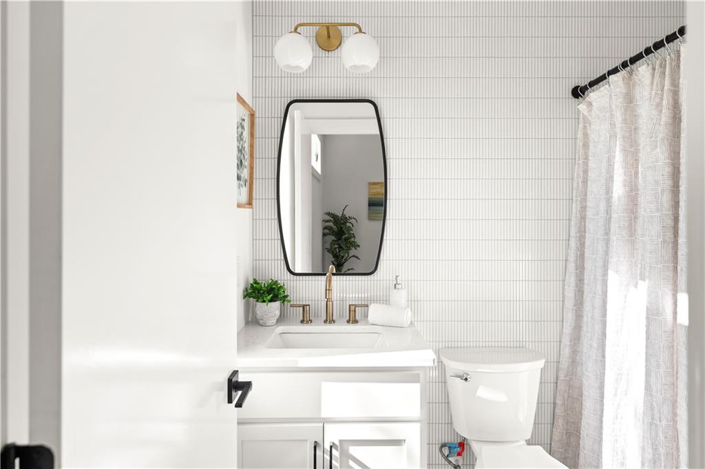 845 Ormewood Terrace Southeast, Unit C Atlanta, GA 30316 - Photo 11 of 37 a bathroom with a sink vanity mirror and toilet