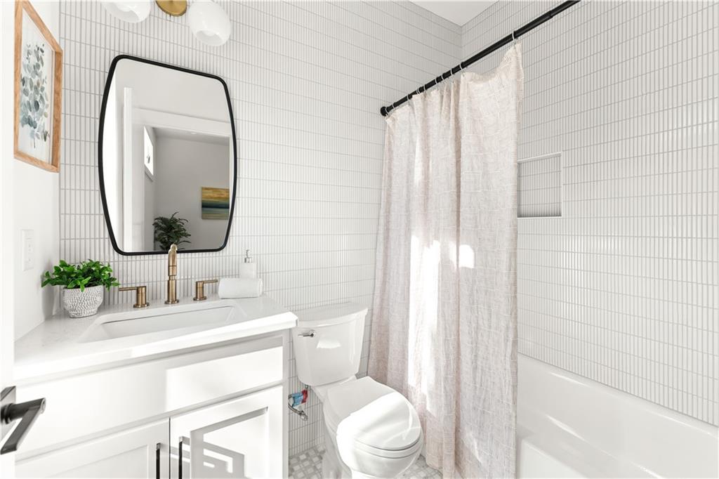 845 Ormewood Terrace Southeast, Unit C Atlanta, GA 30316 - Photo 13 of 37 a bathroom with a sink mirror vanity and toilet