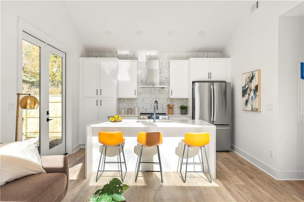 845 Ormewood Terrace Southeast, Unit C Atlanta, GA 30316 - Photo 16 of 37 a view of a kitchen with dining table and chairs