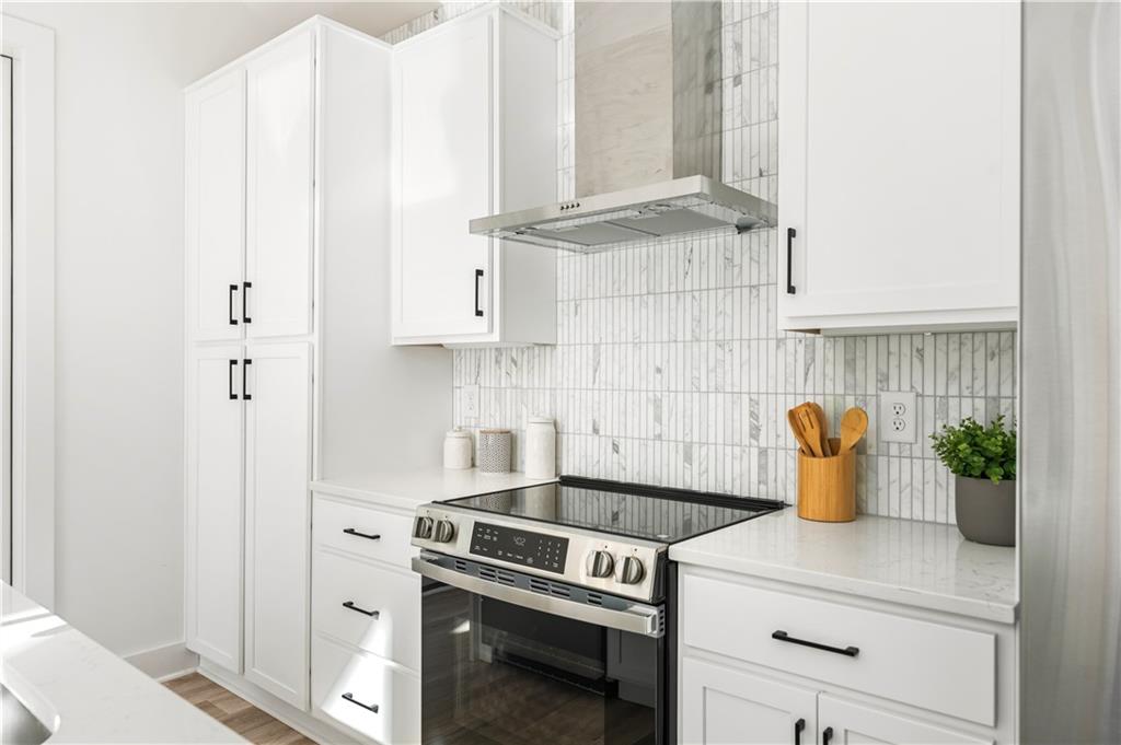 845 Ormewood Terrace Southeast, Unit C Atlanta, GA 30316 - Photo 21 of 37 a kitchen with a stove and a white cabinet