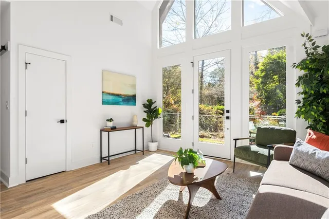 a view of a house with a small yard and wooden fence