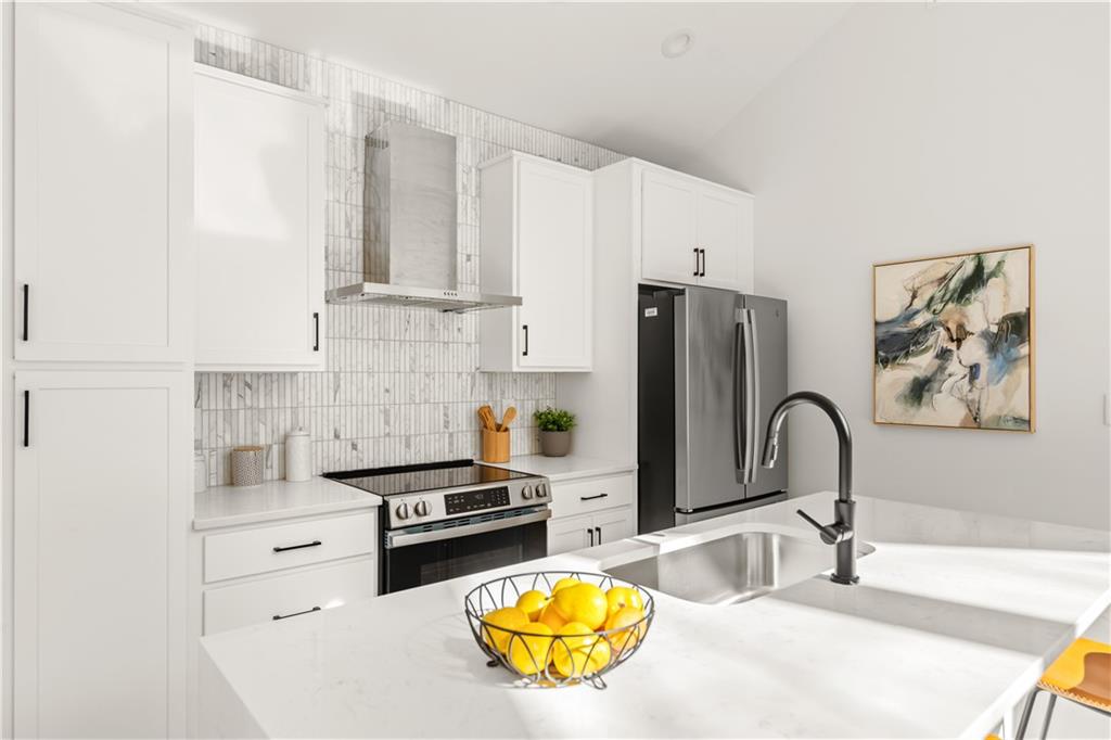845 Ormewood Terrace Southeast, Unit C Atlanta, GA 30316 - Photo 4 of 37 a kitchen with granite countertop a stove a sink and a refrigerator