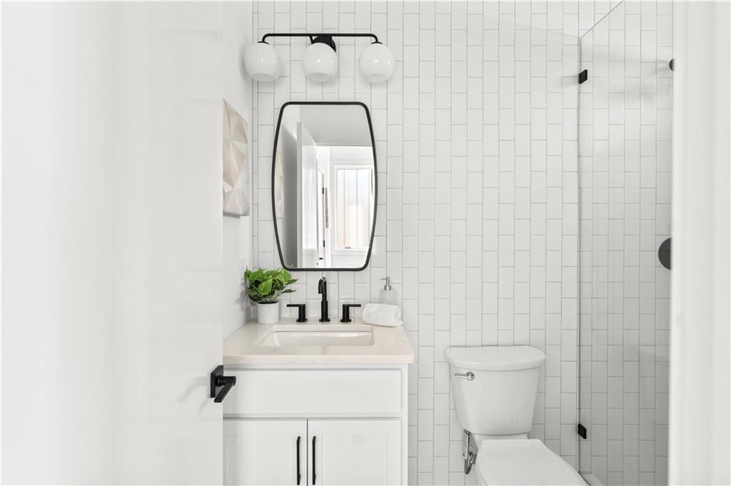 845 Ormewood Terrace Southeast, Unit C Atlanta, GA 30316 - Photo 8 of 37 a bathroom with a toilet sink and mirror