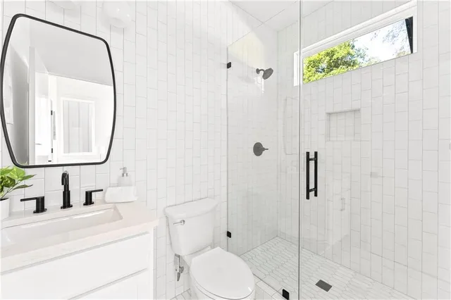 a bedroom with a large bed and a potted plant