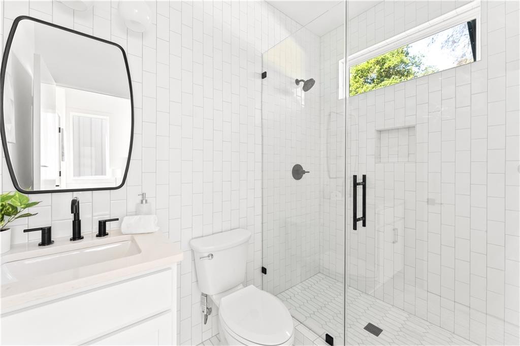 845 Ormewood Terrace Southeast, Unit C Atlanta, GA 30316 - Photo 9 of 37 a bathroom with a toilet sink vanity granite and shower