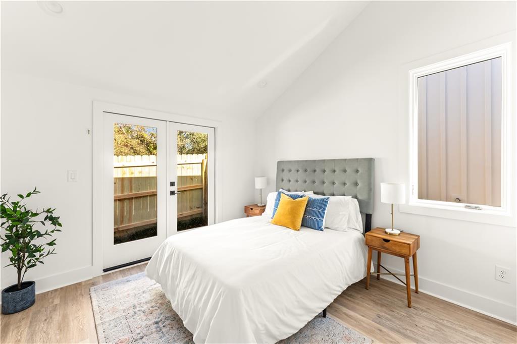 845 Ormewood Terrace Southeast, Unit C Atlanta, GA 30316 - Photo 10 of 37 a bedroom with a large bed and a potted plant