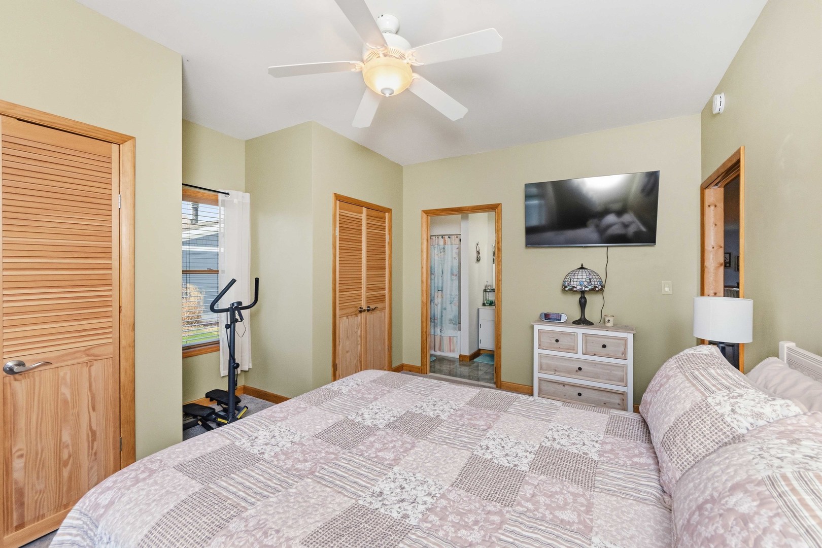 620 West 6th Street Minonk, IL 61760 - Photo 17 of 35 a bedroom with a bed and a flat tv screen on wall