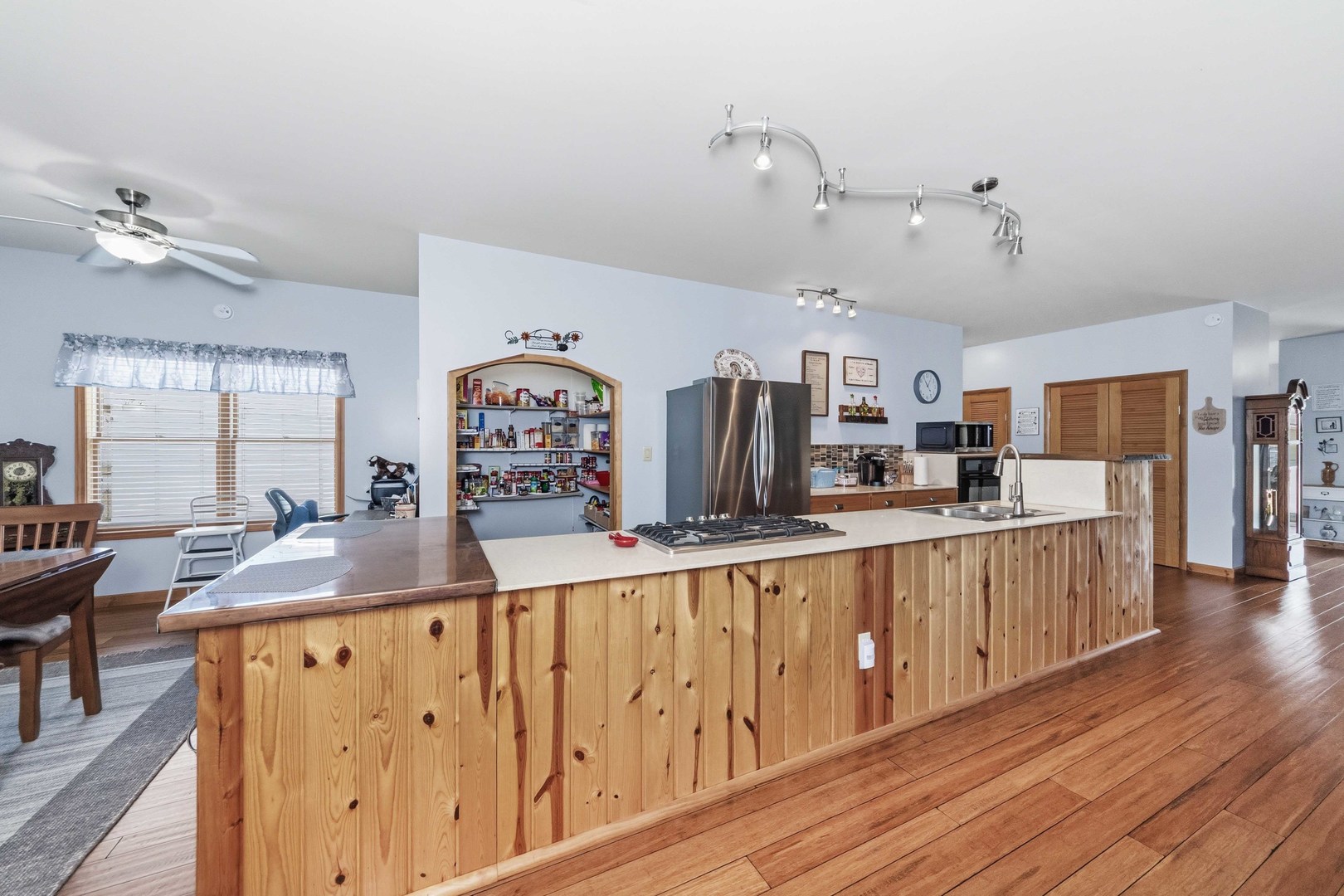 620 West 6th Street Minonk, IL 61760 - Photo 2 of 35 a kitchen with stainless steel appliances granite countertop a sink dishwasher and a dining table with wooden floor