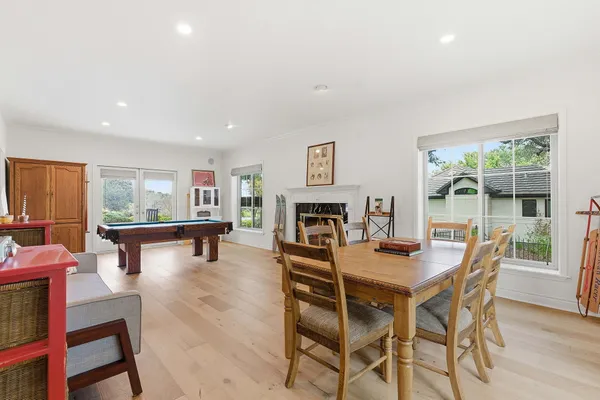 a dining room with furniture and a fireplace