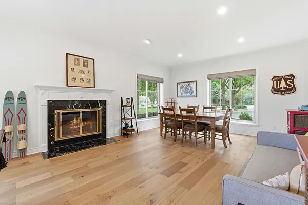 a living room with furniture a window and a fireplace