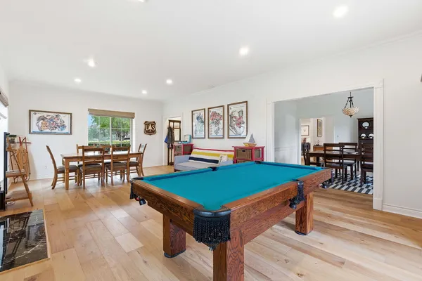 a room with furniture pool table and windows