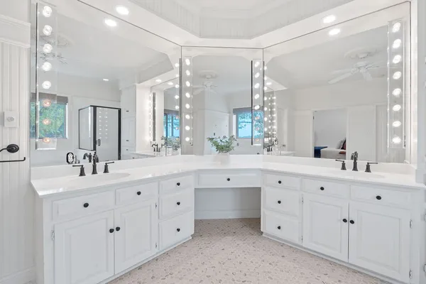 a bathroom with a double vanity sink mirror and double