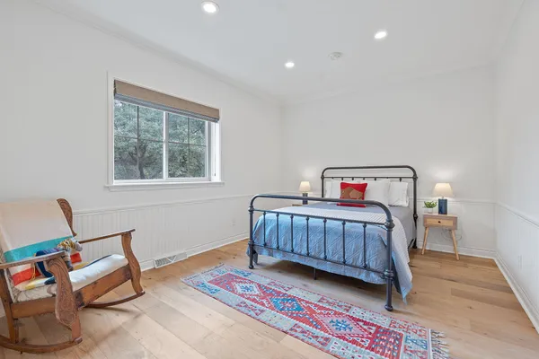a bedroom with furniture and a window