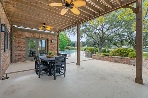 a view of a patio with a table chairs and a backyard