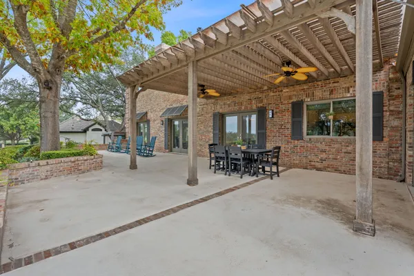 a view of a patio with table and chairs and potted plants