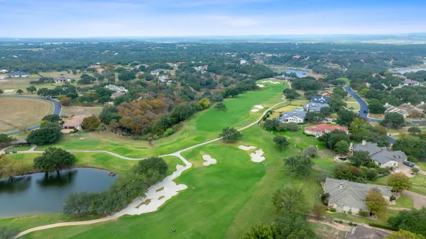 an aerial view of residential houses with outdoor space and river