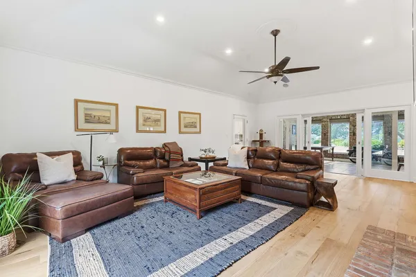 a living room with furniture ceiling fan and a rug