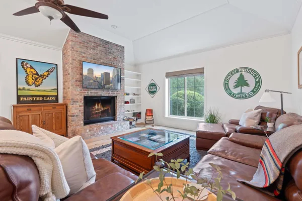 a living room with furniture a window and a fireplace
