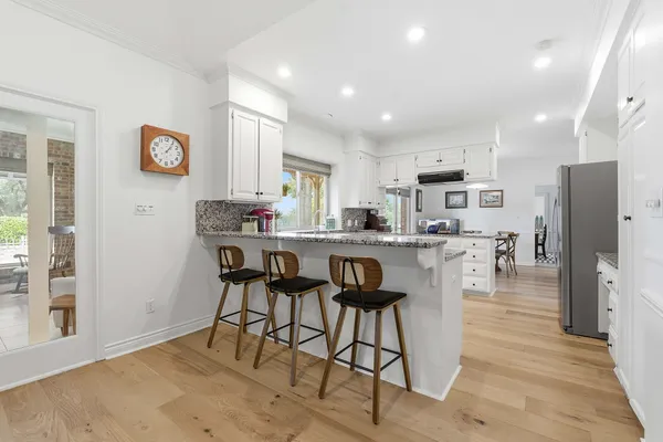 a kitchen with stainless steel appliances granite countertop a refrigerator and a stove top oven