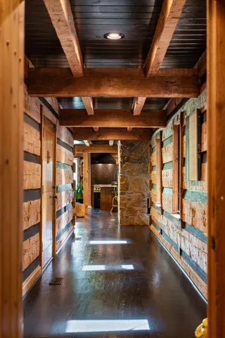 a dining hall with stainless steel appliances granite countertop a stove a refrigerator a dining table and chairs with wooden floor