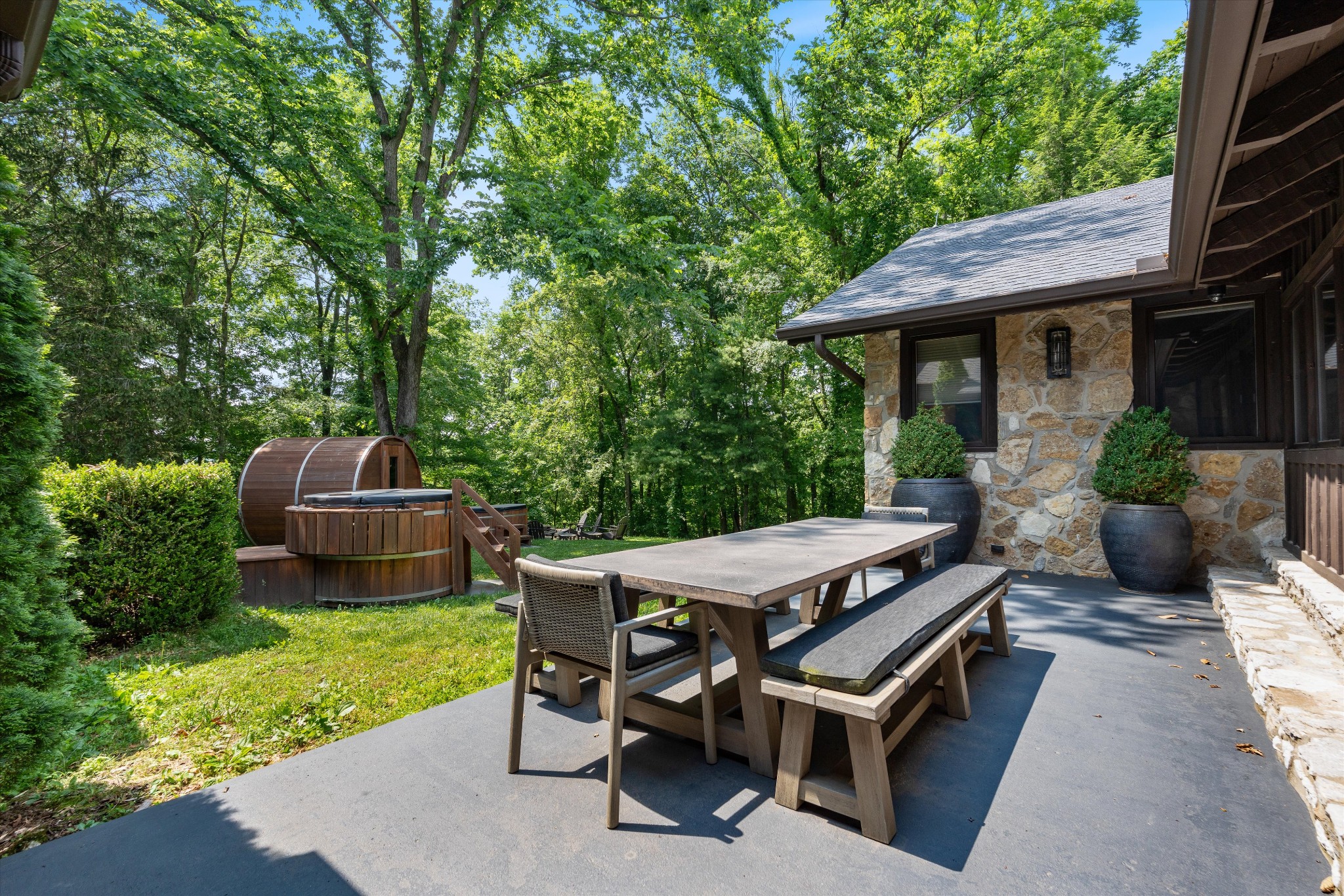 3360 Sweeney Hollow Road Franklin, TN 37064 - Photo 35 of 67 a view of a patio with table and chairs potted plants with wooden fence