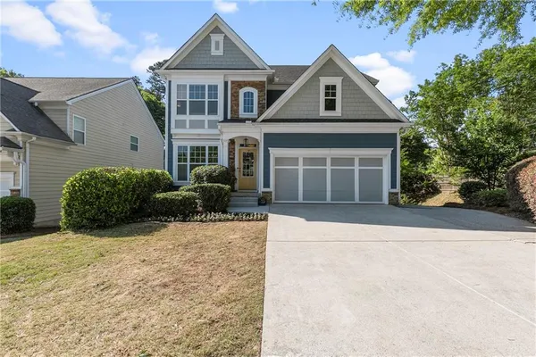 a front view of a house with a yard and garage
