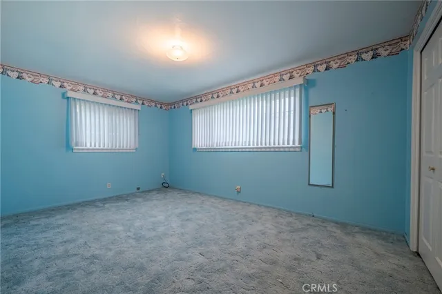 a view of an empty room with windows