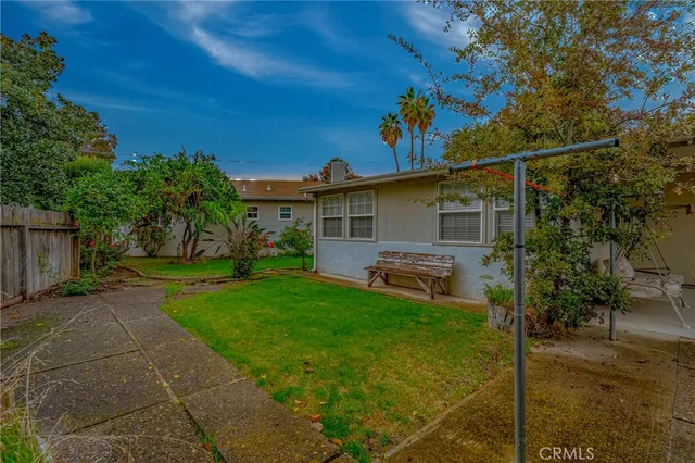 a view of a house with backyard and sitting area