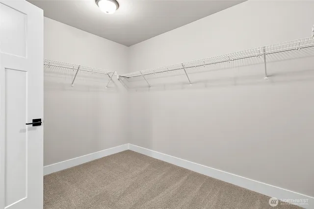 a view of a house with a yard and wooden fence