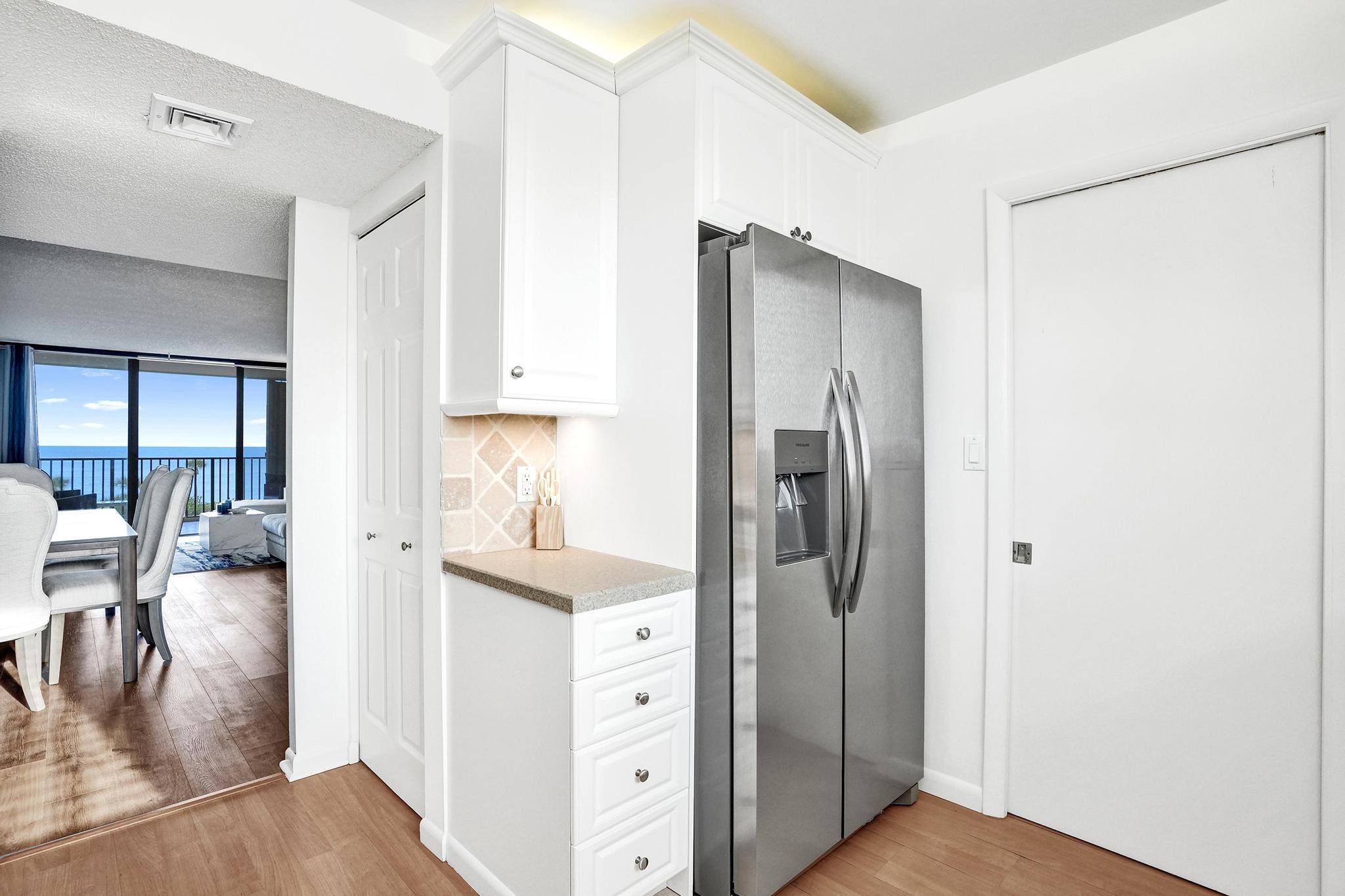 300 Ocean Trail Way, Unit 410 Jupiter, FL 33477 - Photo 18 of 58 a kitchen with stainless steel appliances a refrigerator and a stove top oven