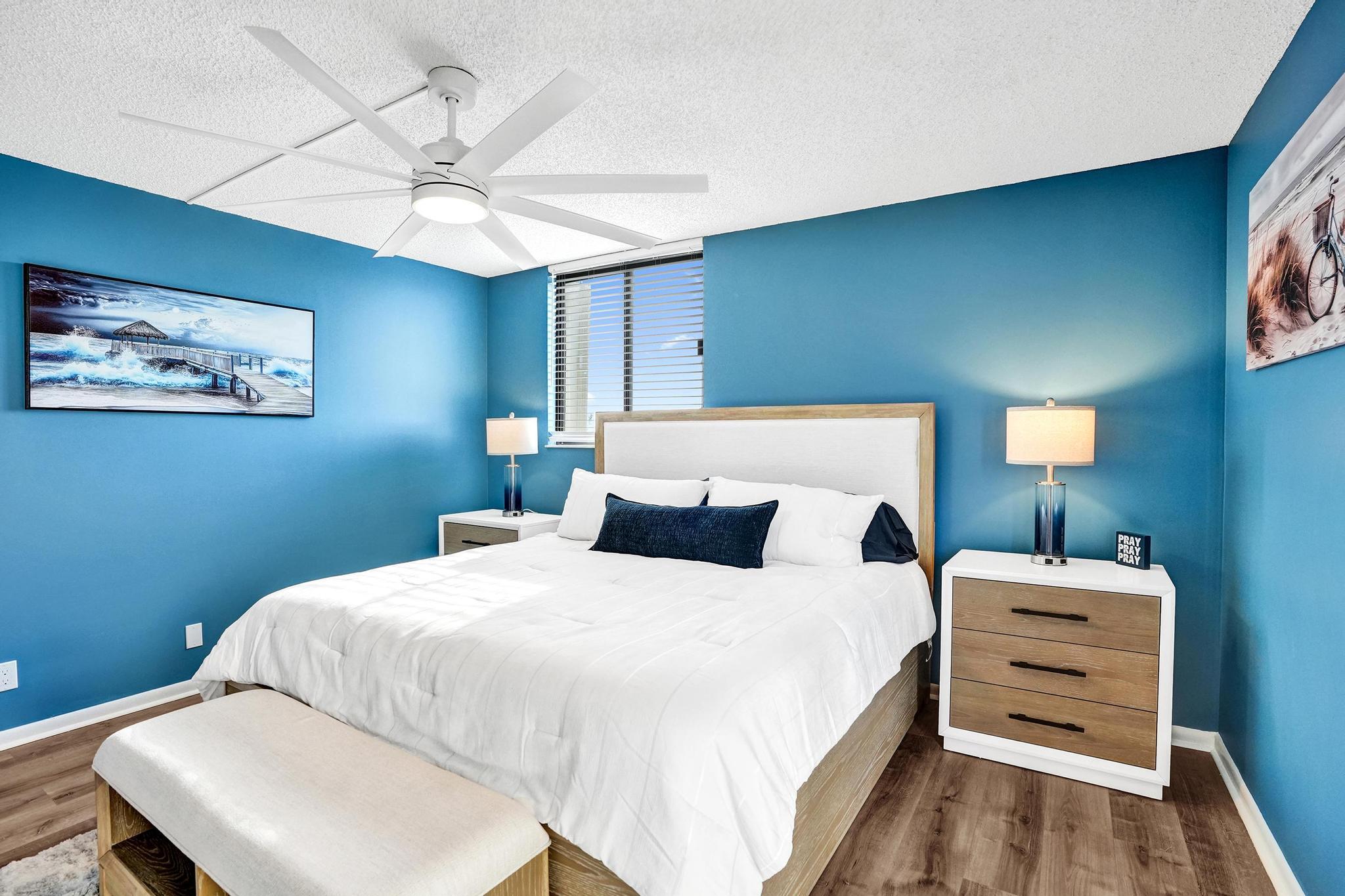 300 Ocean Trail Way, Unit 410 Jupiter, FL 33477 - Photo 23 of 58 a bedroom with a bed and a chandelier