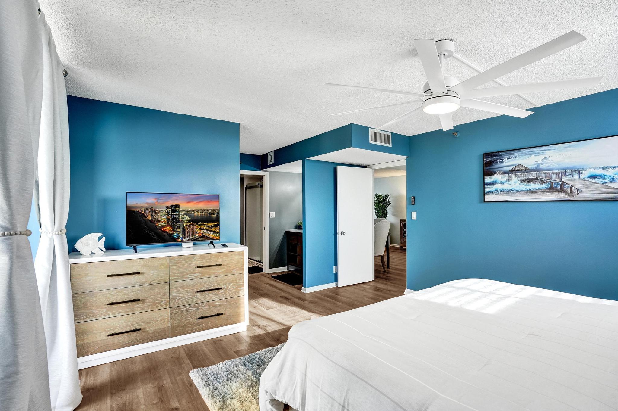 300 Ocean Trail Way, Unit 410 Jupiter, FL 33477 - Photo 25 of 58 a bedroom with a bed and a flat screen tv