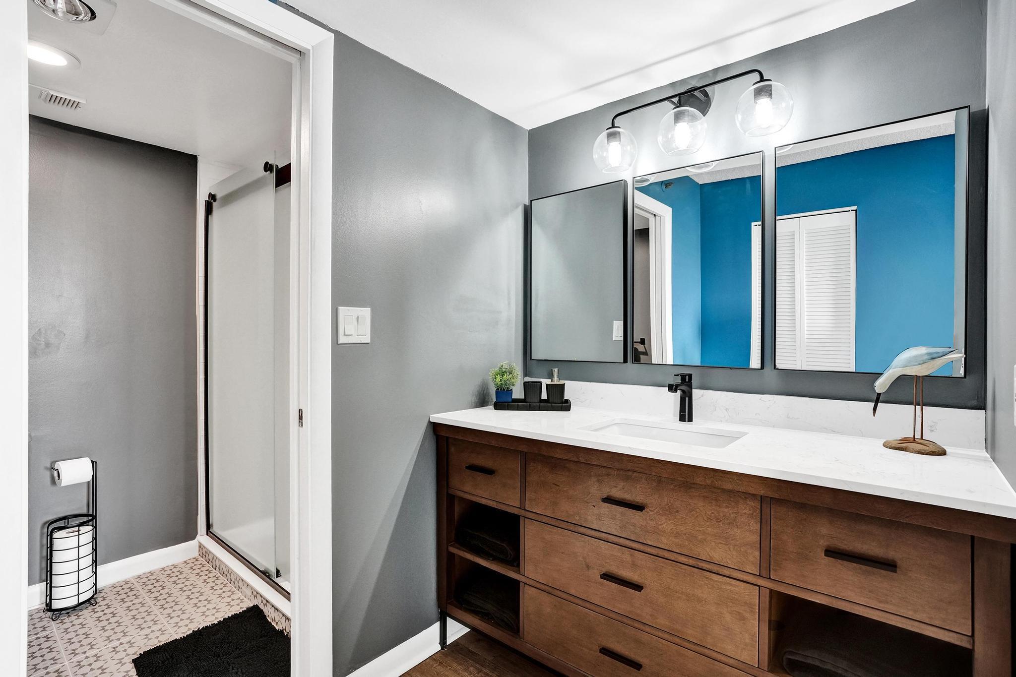 300 Ocean Trail Way, Unit 410 Jupiter, FL 33477 - Photo 28 of 58 a bathroom with a double vanity sink and a mirror