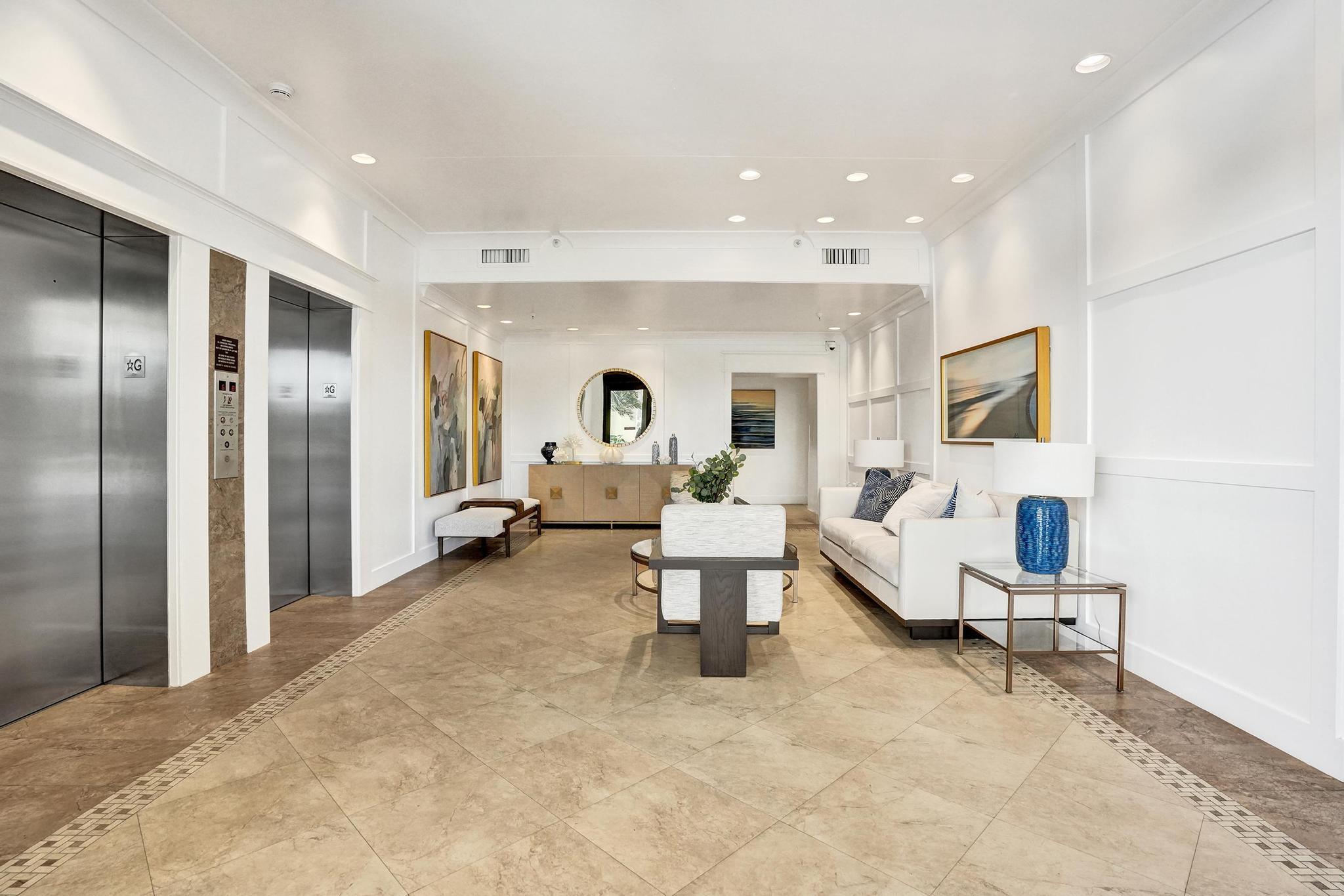 300 Ocean Trail Way, Unit 410 Jupiter, FL 33477 - Photo 51 of 58 a living room with furniture and a table