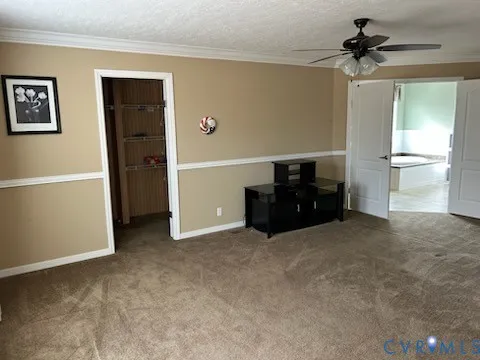 a view of a livingroom with a ceiling fan and window