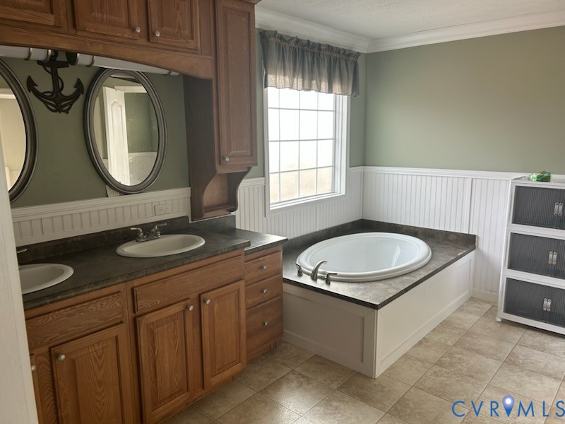 15910 Nobles Road Disputanta, VA 23842 - Photo 6 of 7 Full bathroom featuring a bath, a wainscoted wall,