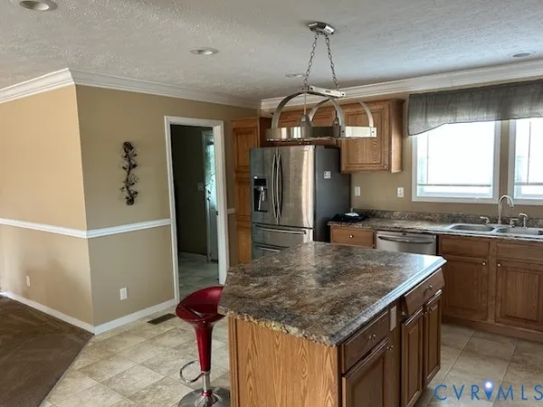 a kitchen with kitchen island a counter top space appliances and cabinets
