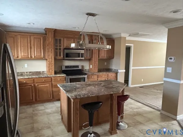 a kitchen with a stove a sink and a microwave