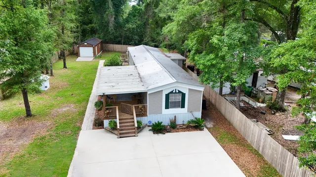 an aerial view of a house with a yard