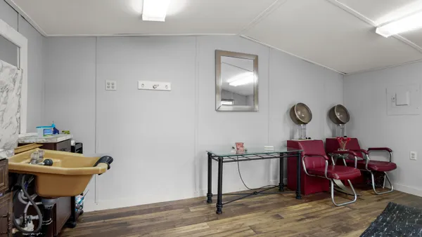 a reading room with furniture and wooden floor