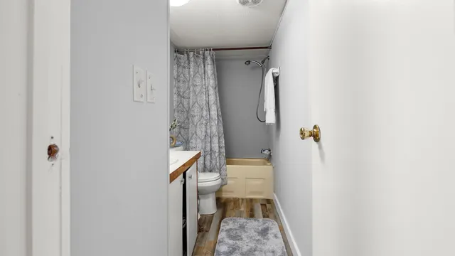 a bathroom with a sink toilet and shower