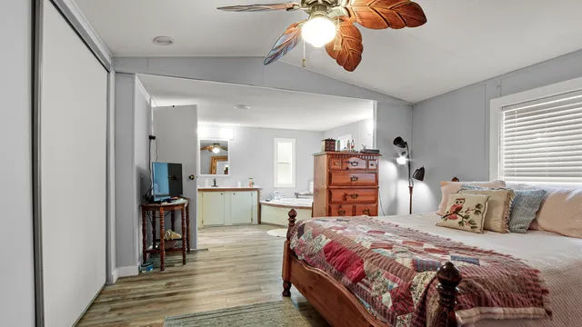 a bedroom with a bed and wooden floor